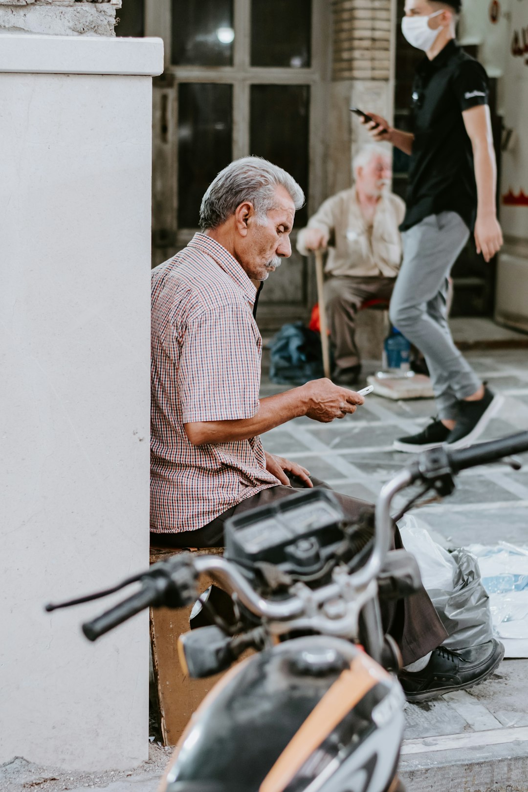 man in white and black stripe shirt riding motorcycle