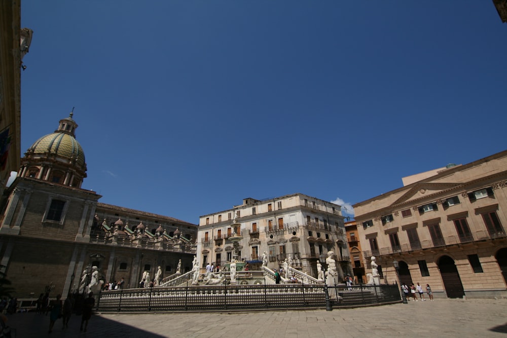 people walking on sidewalk near buildings during daytime