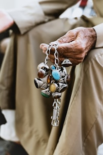 person wearing silver blue and green beaded bracelet