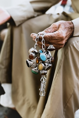 person wearing silver blue and green beaded bracelet