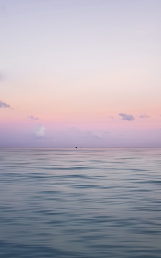 blue sea under blue sky during daytime in Raa Atoll Maldives