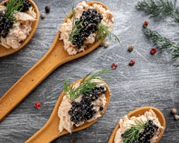 brown wooden spoon with black and white berries