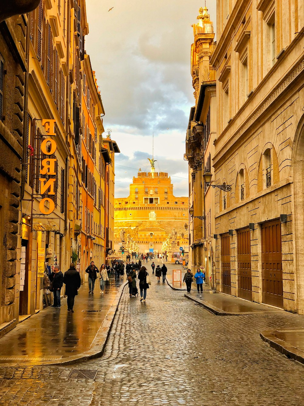 people walking on street between buildings during daytime