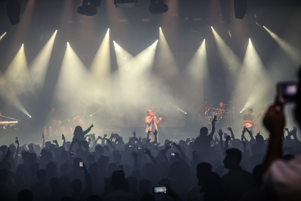 people standing on stage during nighttime