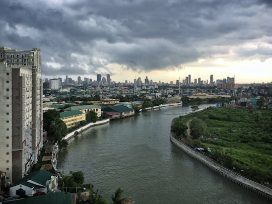 body of water near city buildings during daytime in Manila Philippines