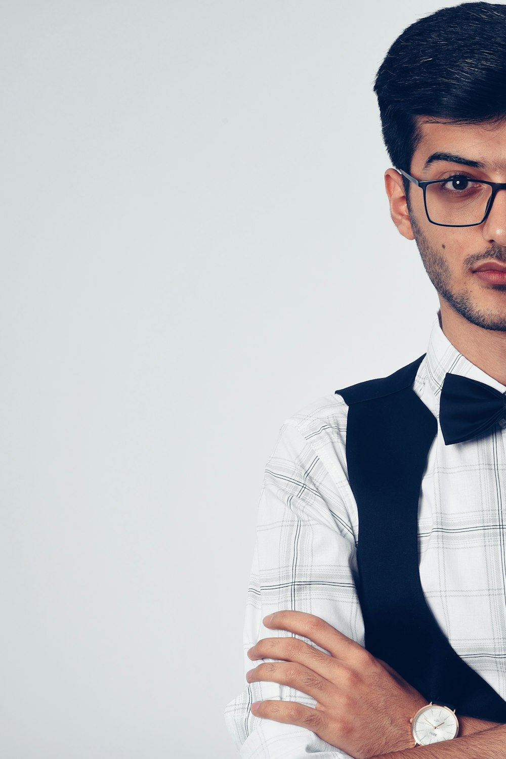 man in white and blue plaid button up shirt wearing black framed eyeglasses