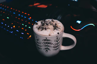 A sleek mug with bold gamer graphics and neon accents, set against a dark backdrop.