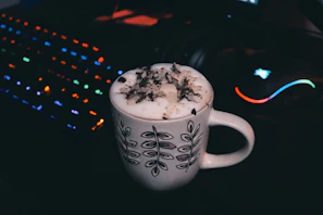 A sleek mug with bold gamer graphics and neon accents, set against a dark backdrop.