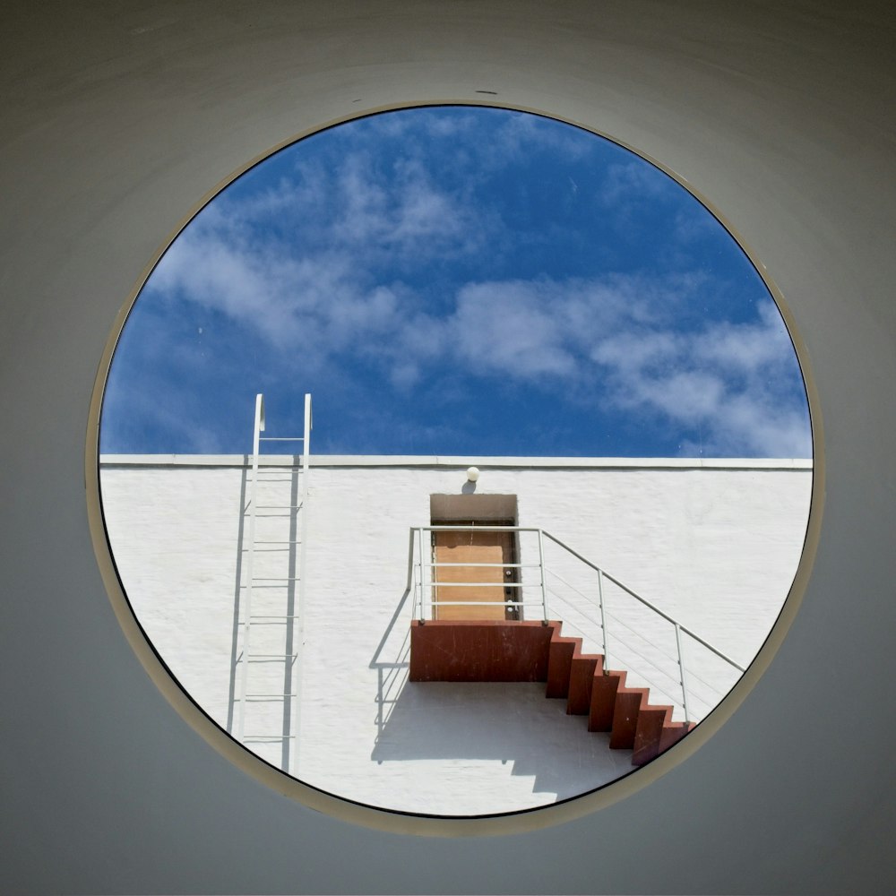 white and brown concrete building under blue sky and white clouds during daytime