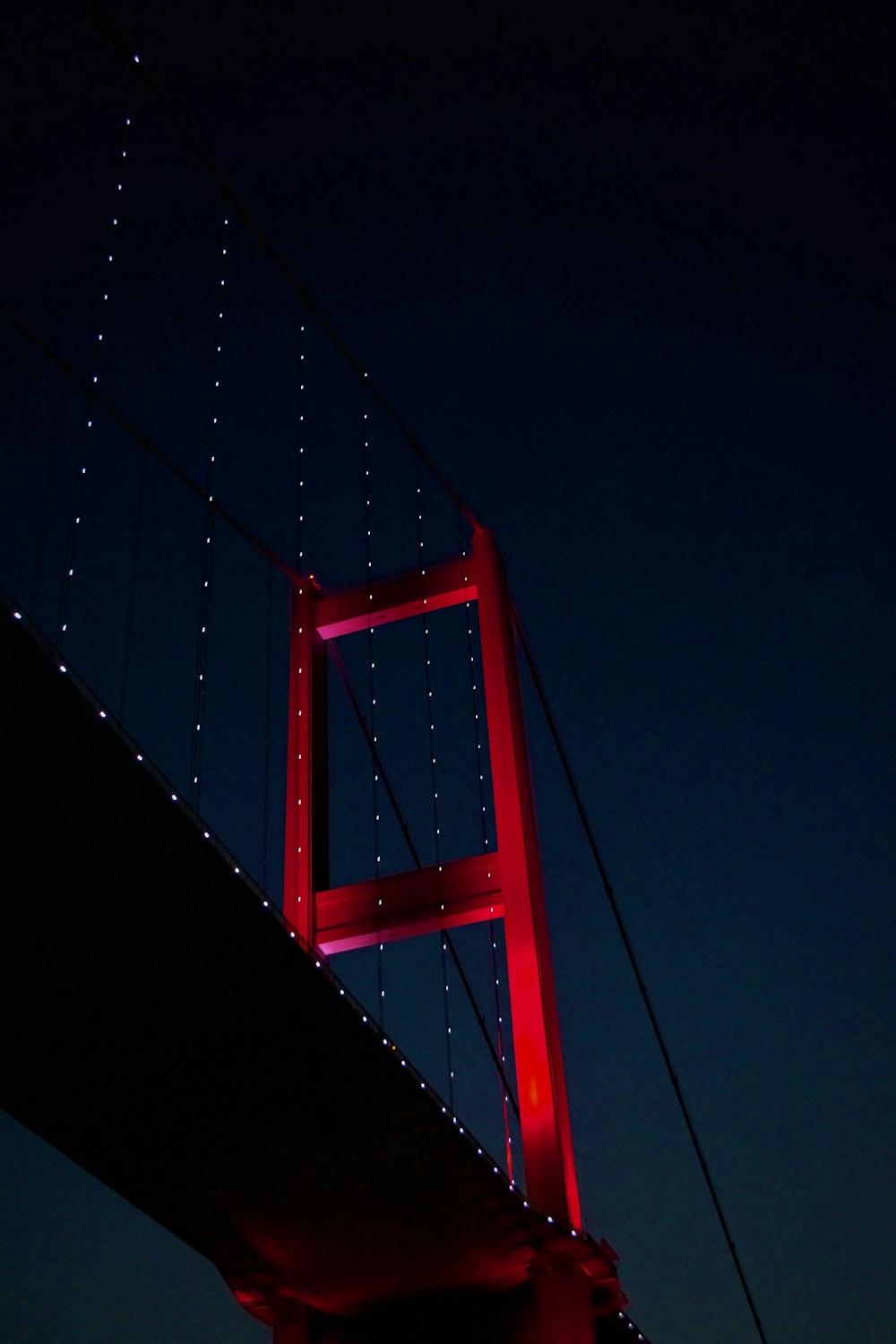 red bridge under blue sky during night time