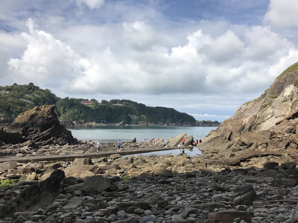 brown rock formation near body of water during daytime