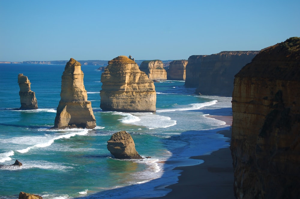 brown rock formation on sea during daytime