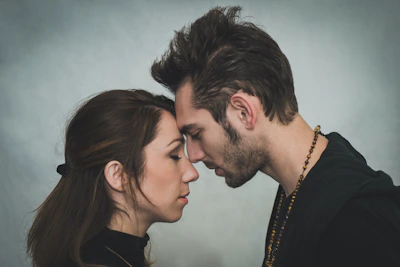 Gentle touch between partners creating a moment of intimate connection.