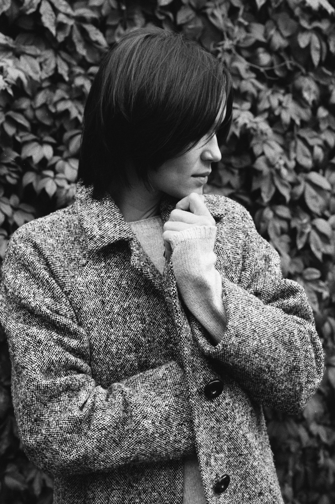 grayscale photo of woman in coat