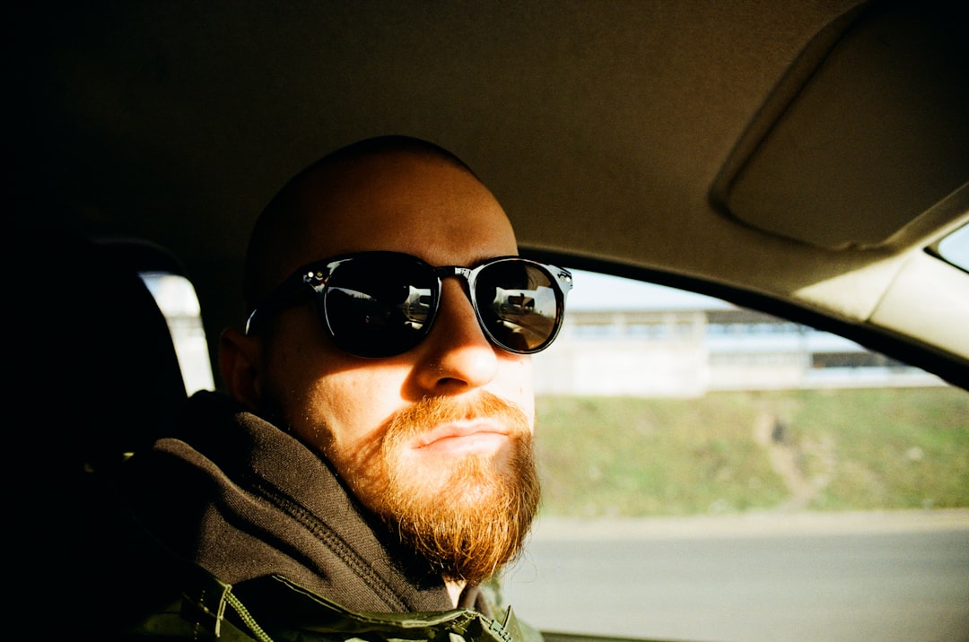 man in green jacket wearing black sunglasses