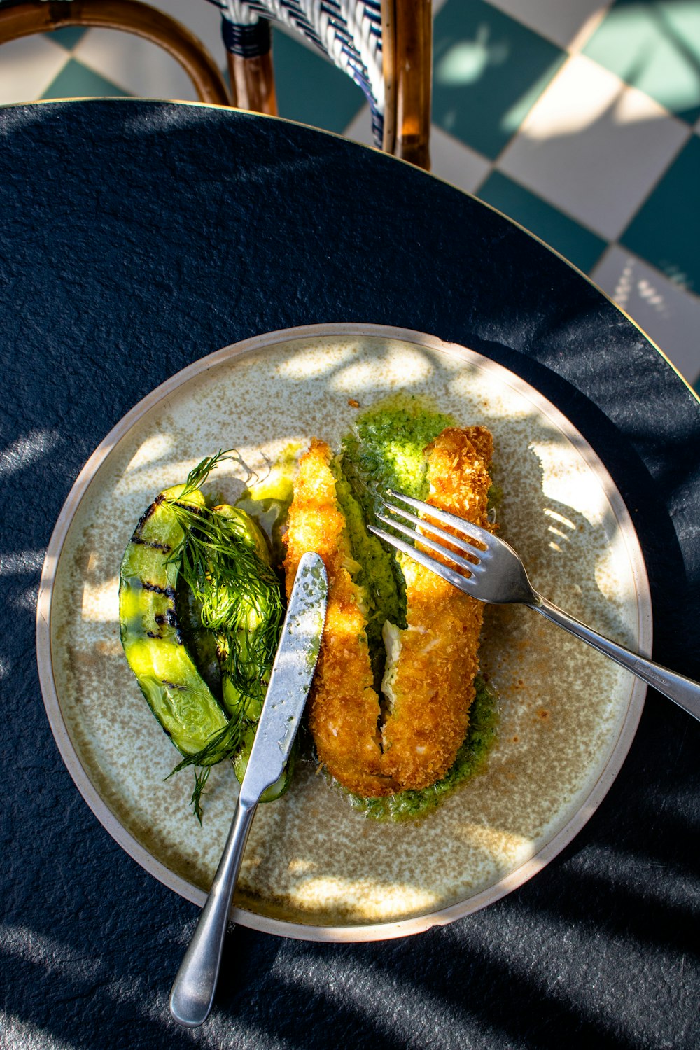 stainless steel fork on green and white ceramic plate