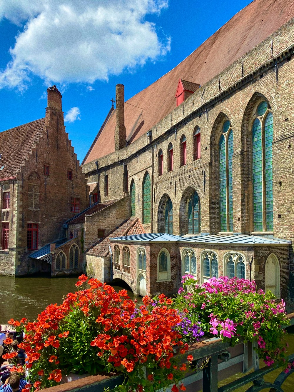 brown brick building near river during daytime