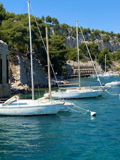 white boat on body of water during daytime