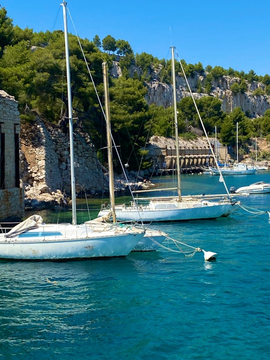 white boat on body of water during daytime in Parc national des Calanques France