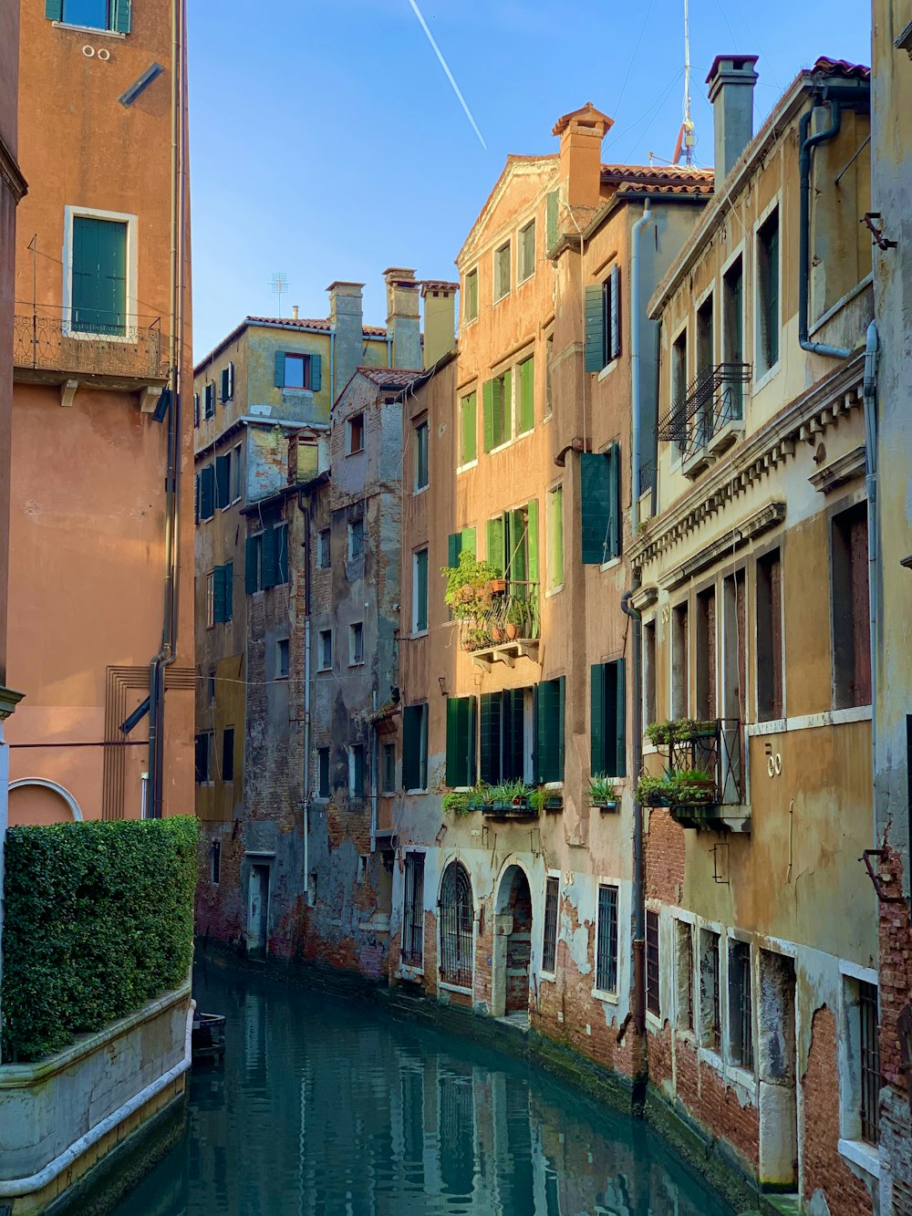 river between concrete buildings during daytime