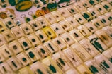 A collection of various insects encased in clear resin blocks, arranged in a grid pattern. The blocks contain a variety of insects, including beetles, spiders, and other arthropods, and are displayed on a flat surface. Some blocks have an amber tint, adding a warm hue to the display.