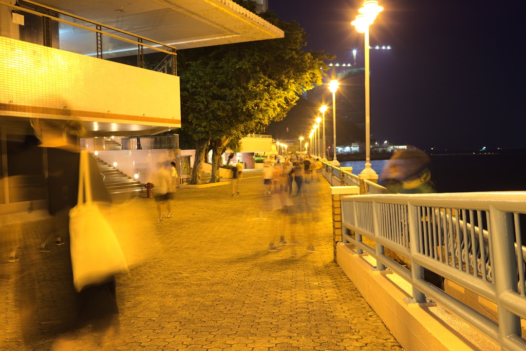 people walking on sidewalk during night time