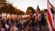 A panoramic view of a large international prayer event at dusk.