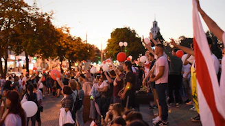A panoramic view of a large international prayer event at dusk.
