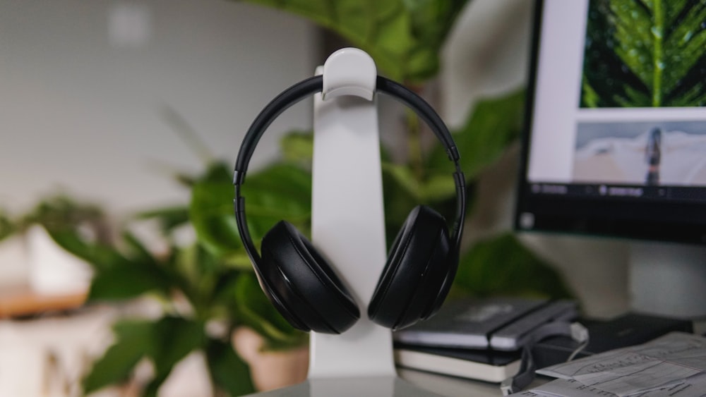 black and white headphones on black laptop computer