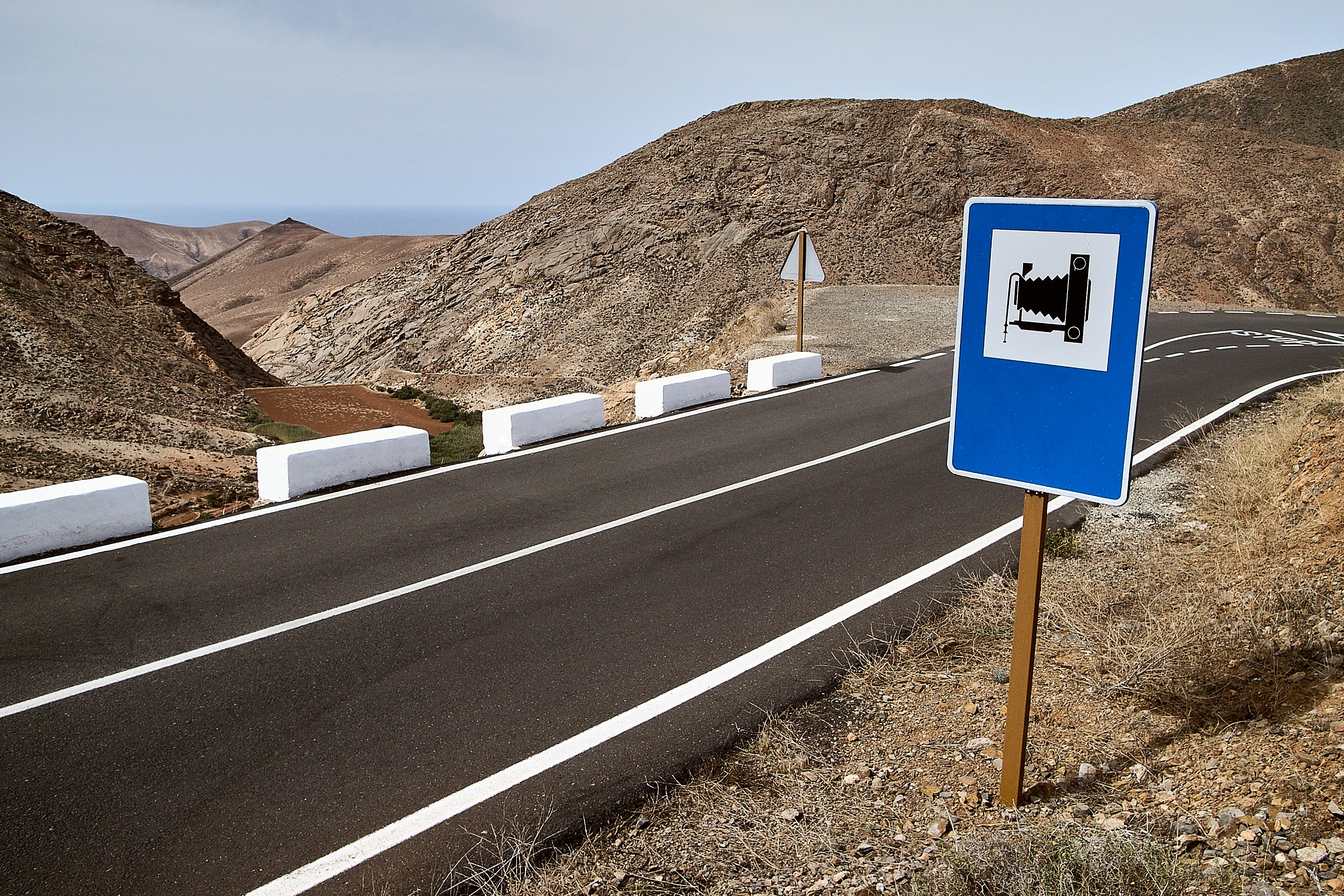 blue and white road sign