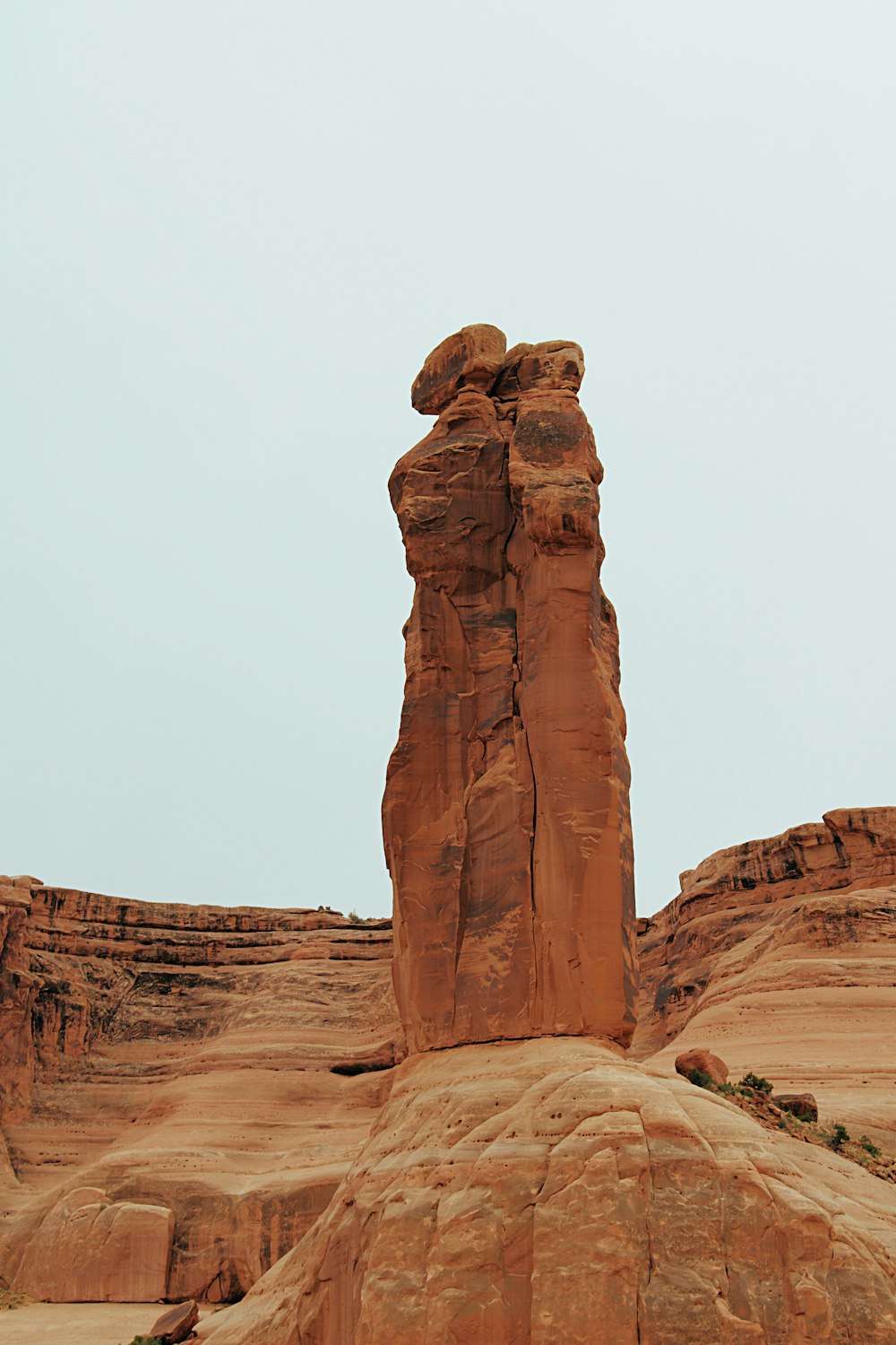 brown rock formation under white sky during daytime