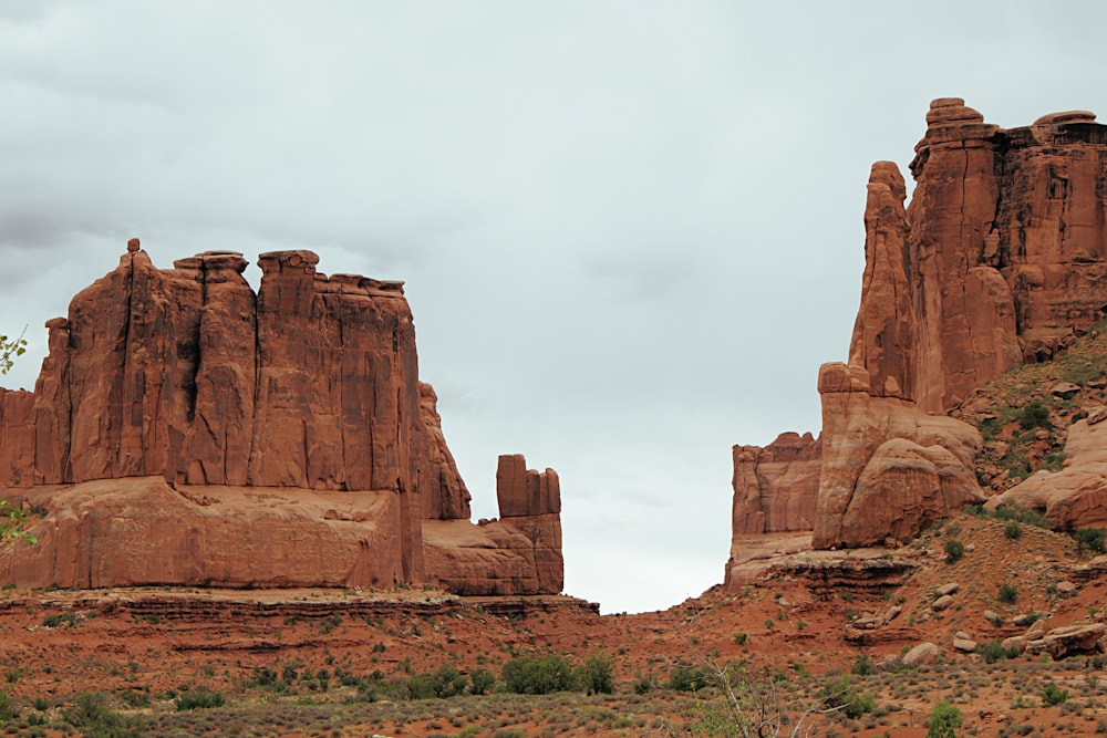 brown rock formation under white sky during daytime