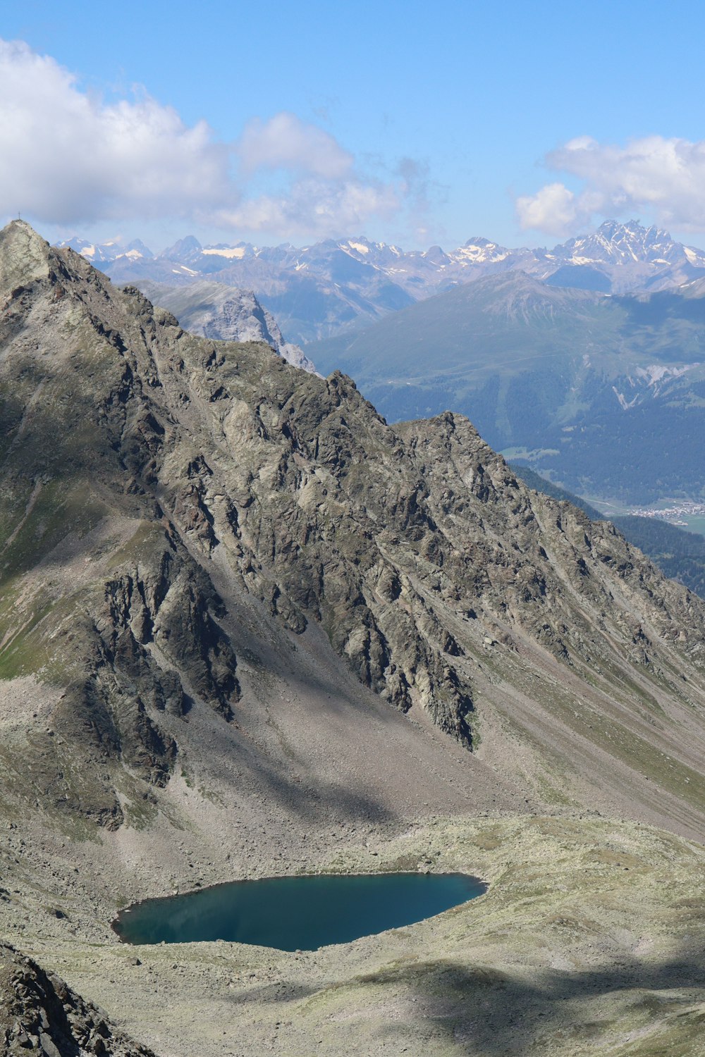 a mountain range with a lake in the foreground