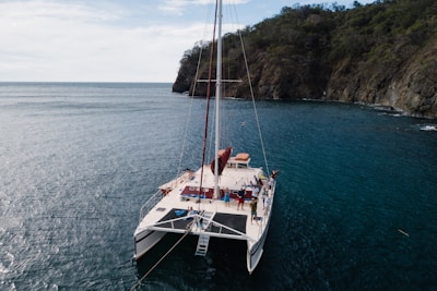 white and brown sail boat on blue sea during daytime