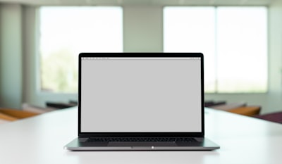 macbook pro on white table laptop google meet background