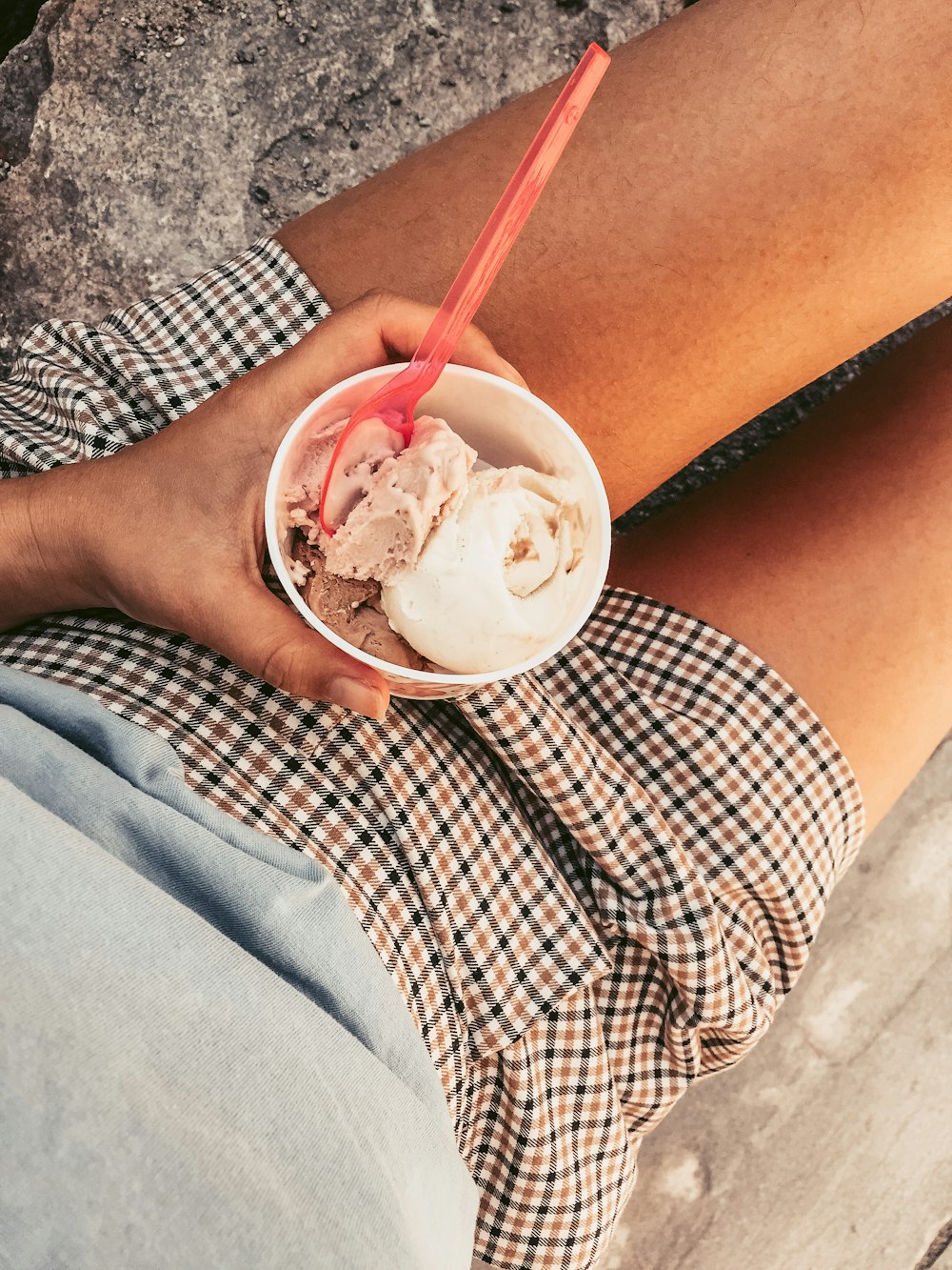 person holding ice cream in white ceramic bowl