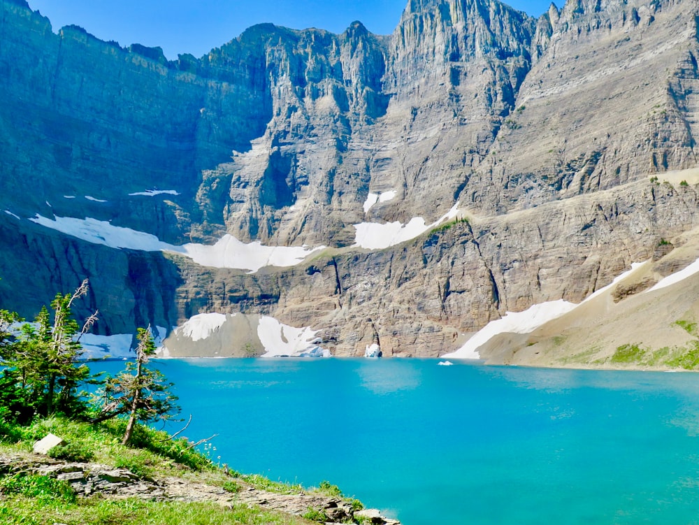 blue lake surrounded by mountains during daytime