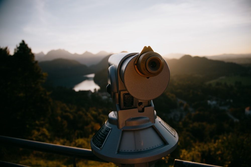 white and black telescope on top of the mountain during daytime