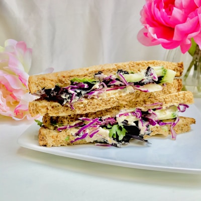 brown bread with pink and white flowers on white ceramic plate