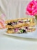 brown bread with pink and white flowers on white ceramic plate