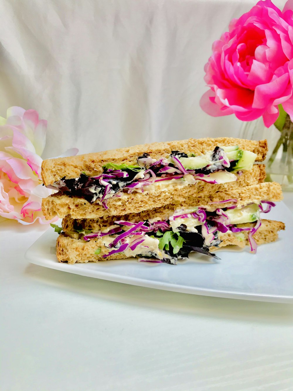 brown bread with pink and white flowers on white ceramic plate