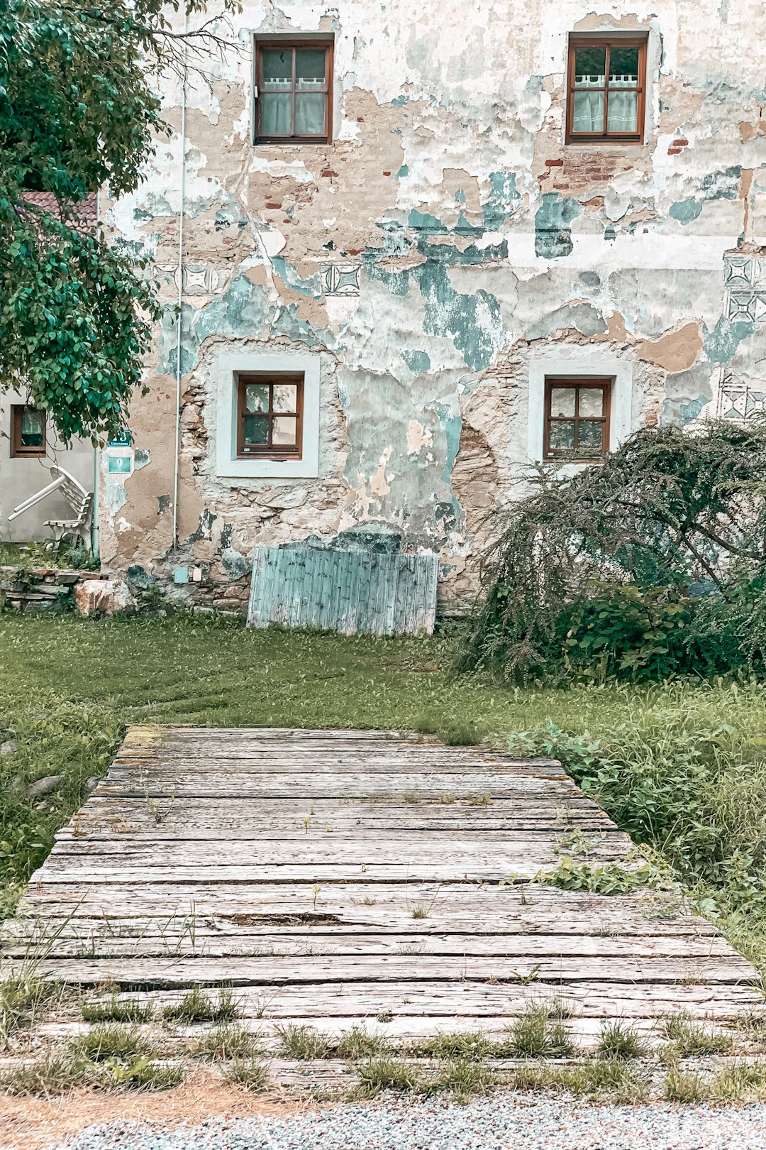 white concrete house near green grass field during daytime