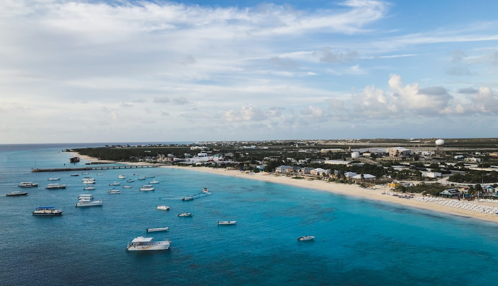 white boats on sea under cloudy sky during daytime