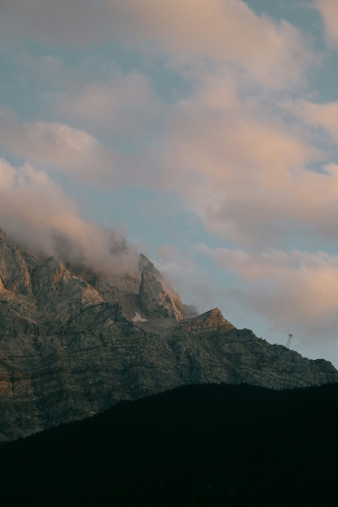 brown rocky mountain under white clouds during daytime