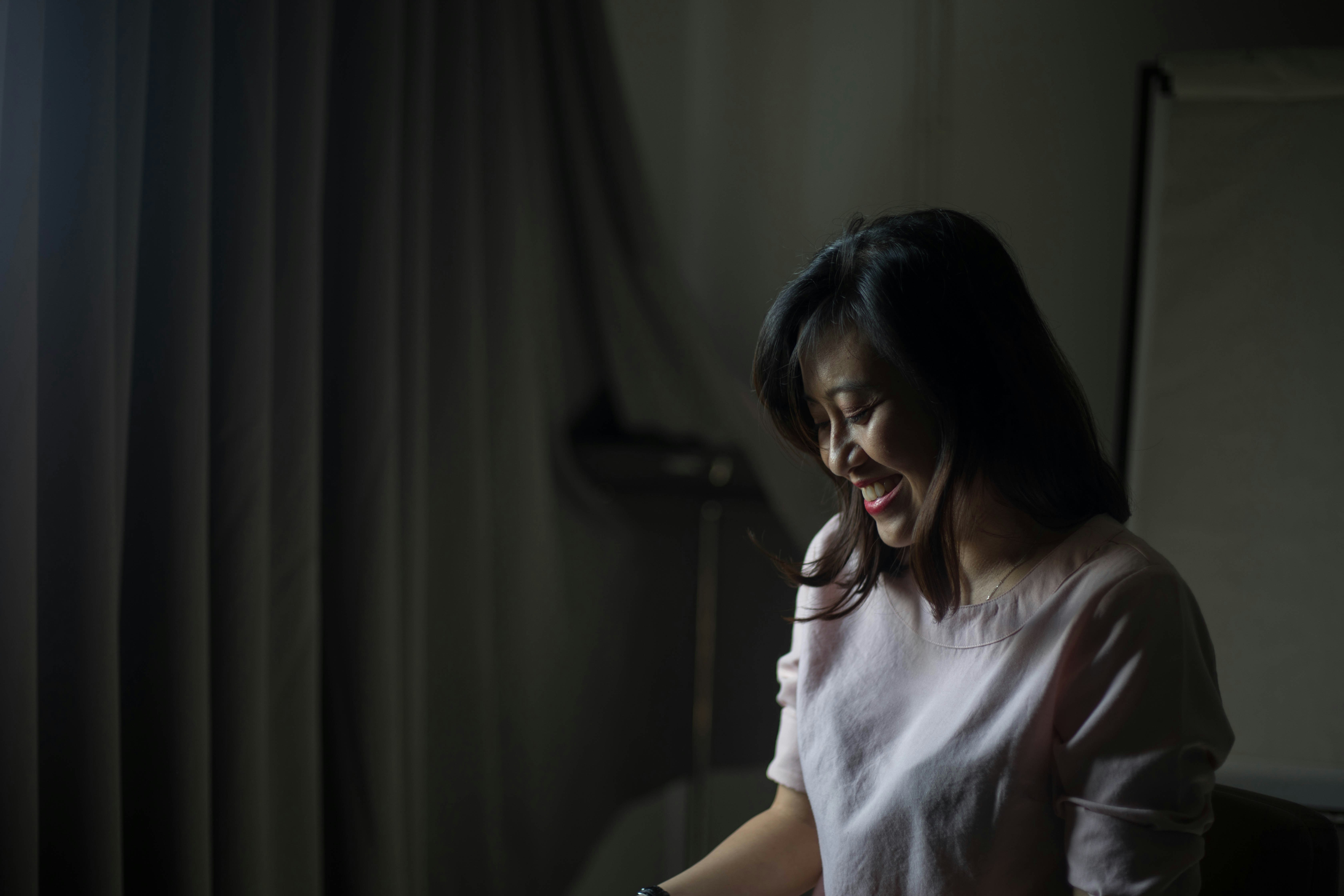 woman in white shirt sitting on chair