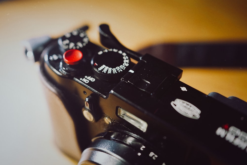 black dslr camera on brown wooden table