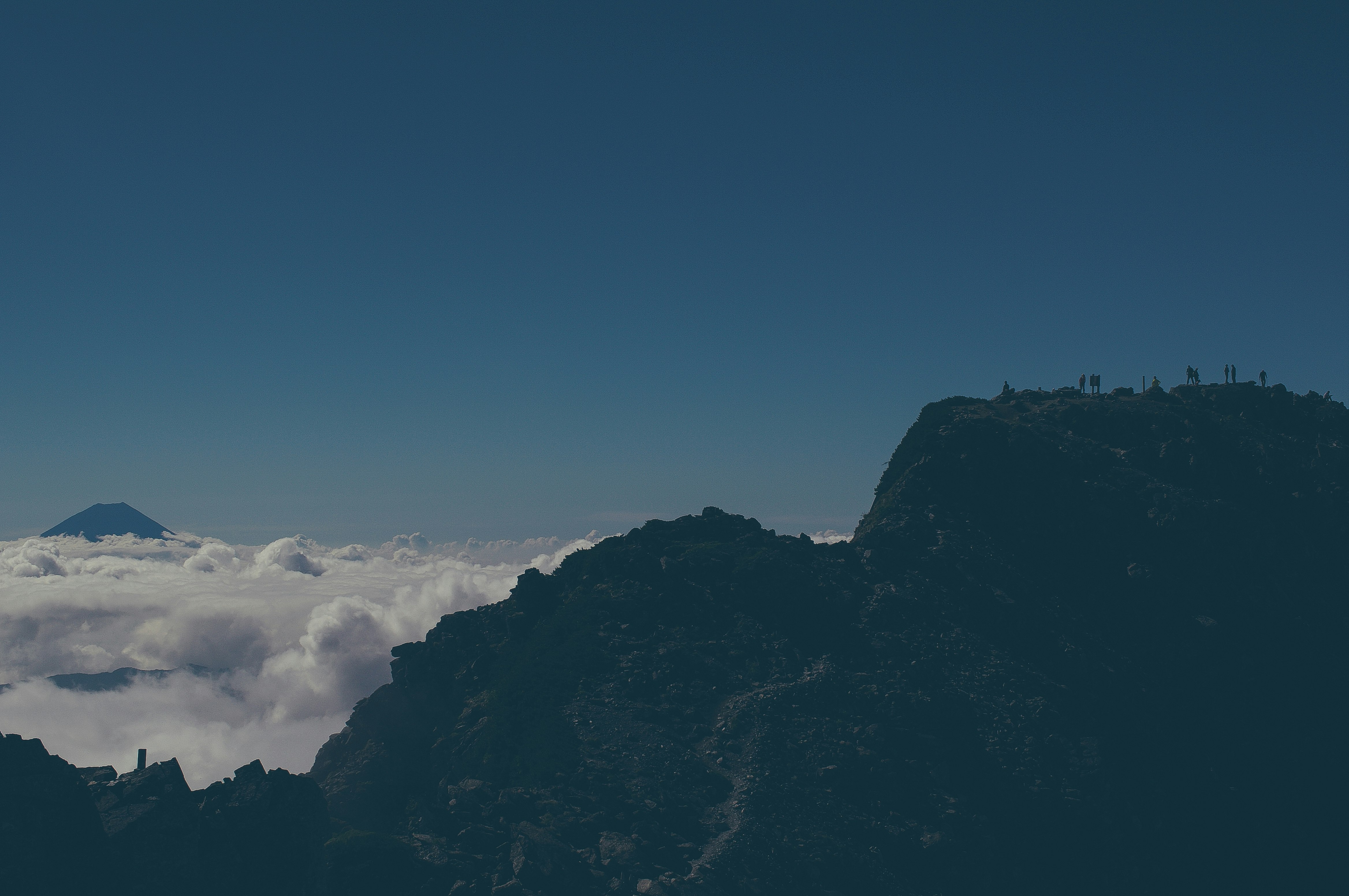 silhouette of mountain under blue sky during daytime