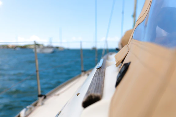 Close-up of a Bavaria 46 sailboat's safety equipment neatly arranged on deck under clear skies.
