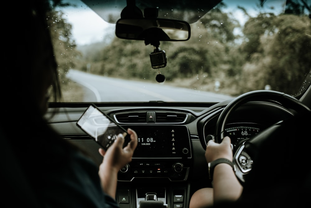 person driving car during daytime