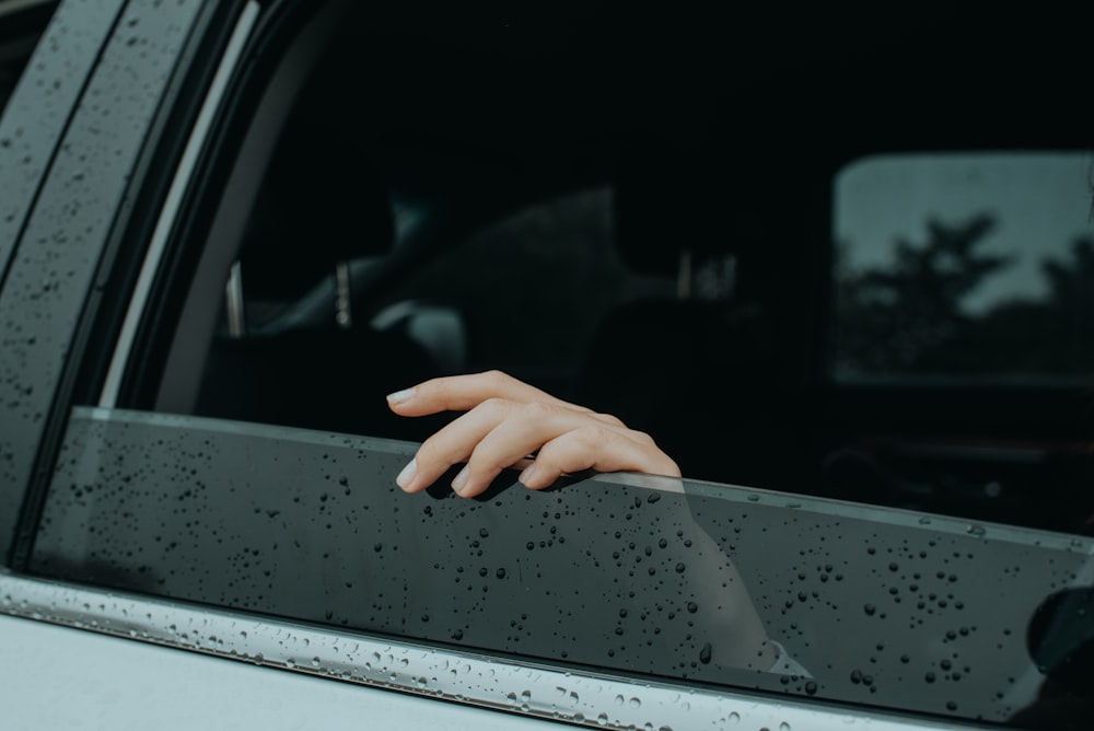 person holding car door during night time